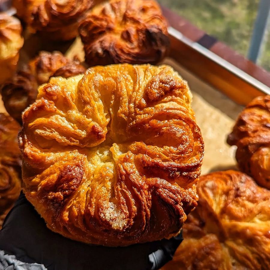 Freshly baked golden-brown fried pastry with a crinkled, fluffy texture