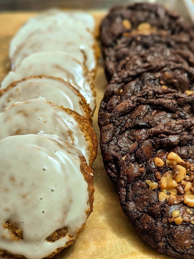 Tray of frosted sugar cookies and chocolate cookies with nuts