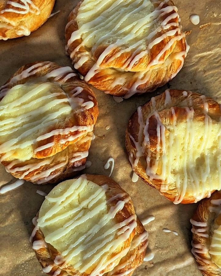 Apple pastries topped with white icing drizzle